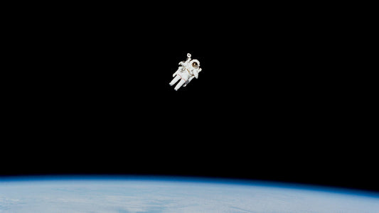 Astronaut floating above the earth, where a surprising number of left-handers have played key roles in space exploration.