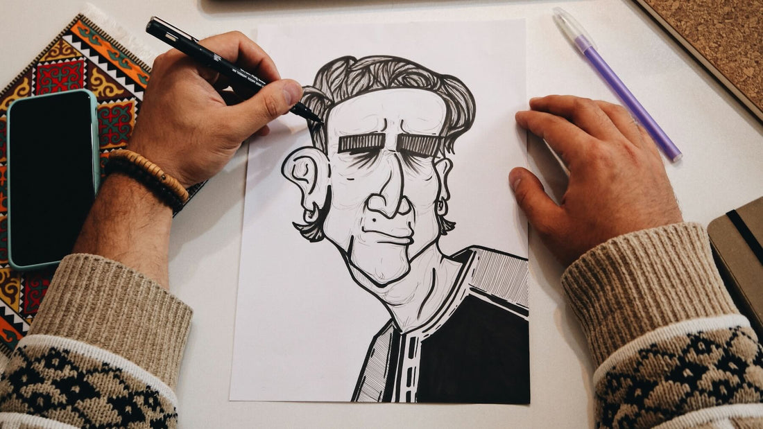 Left-handed artist inking an illustration of a man using black ink, hand positioned to avoid smudging.