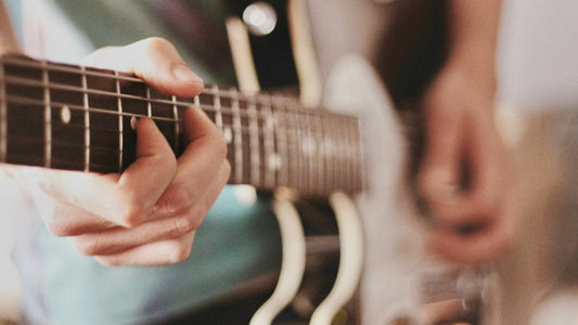 Left-handed guitar player showcasing technique on electric guitar closeup.