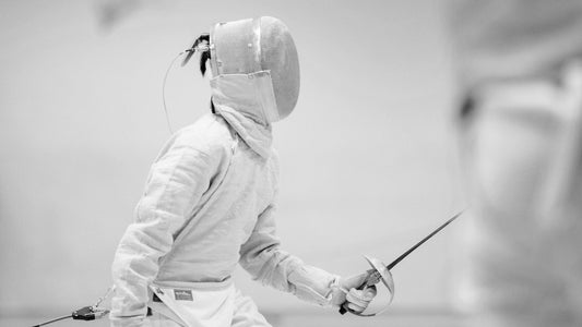 A left-handed sabre fencer during a bout.