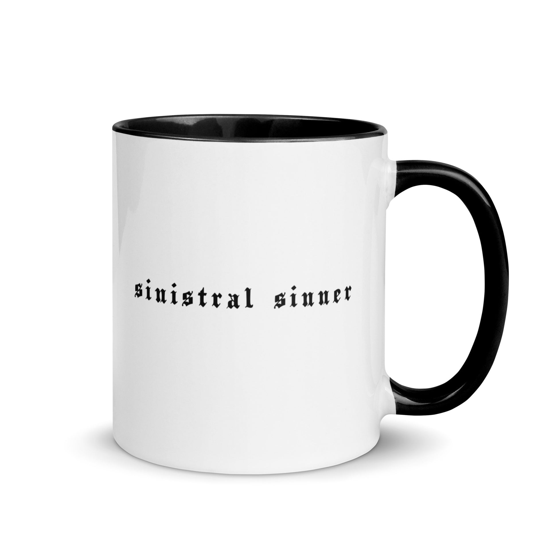 White ceramic mug for left-handers featuring black gothic text "Sinistral Sinner" with black handle and interior.