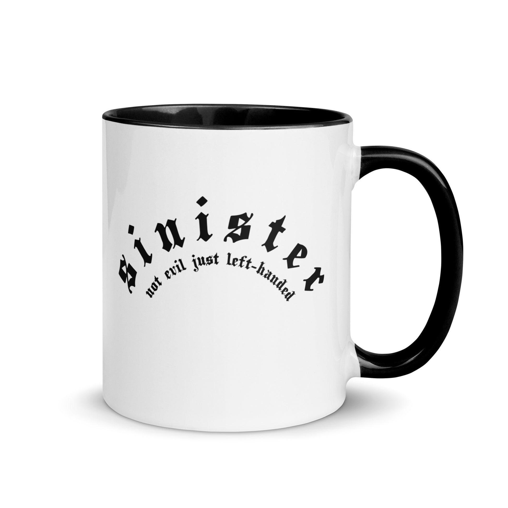 White ceramic mug for left-handers featuring black gothic text "Sinister: Not Evil Just Left-Handed" with black handle and interior.