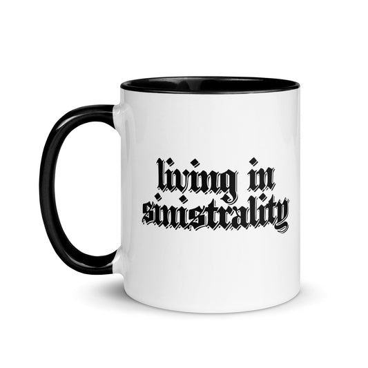 White ceramic mug for left-handers featuring black gothic text "Living in Sinistrality" with black handle and interior.