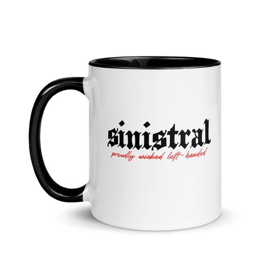White ceramic mug for left-handers featuring black gothic text "Sinistral: Proudly Left-Handed" with black handle and interior.