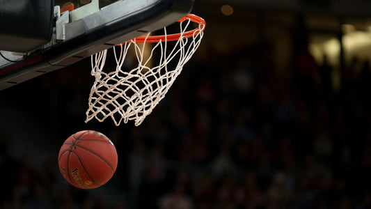 A basketball dropping through the hoop, perfectly captured in motion—a tribute to the precision and skill of left-handed NBA players who defy expectations.