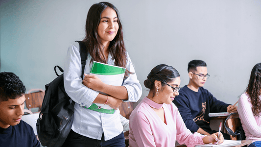 Group of college students, several left-handed, writing notes during a lecture