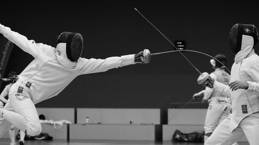 A left-handed épée fencer executing a fleche attack, landing a precise touch on their opponent.