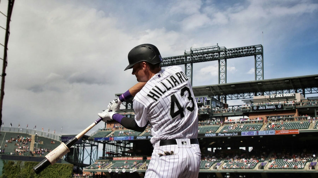 Left-handed baseball player swinging at a pitch during a game