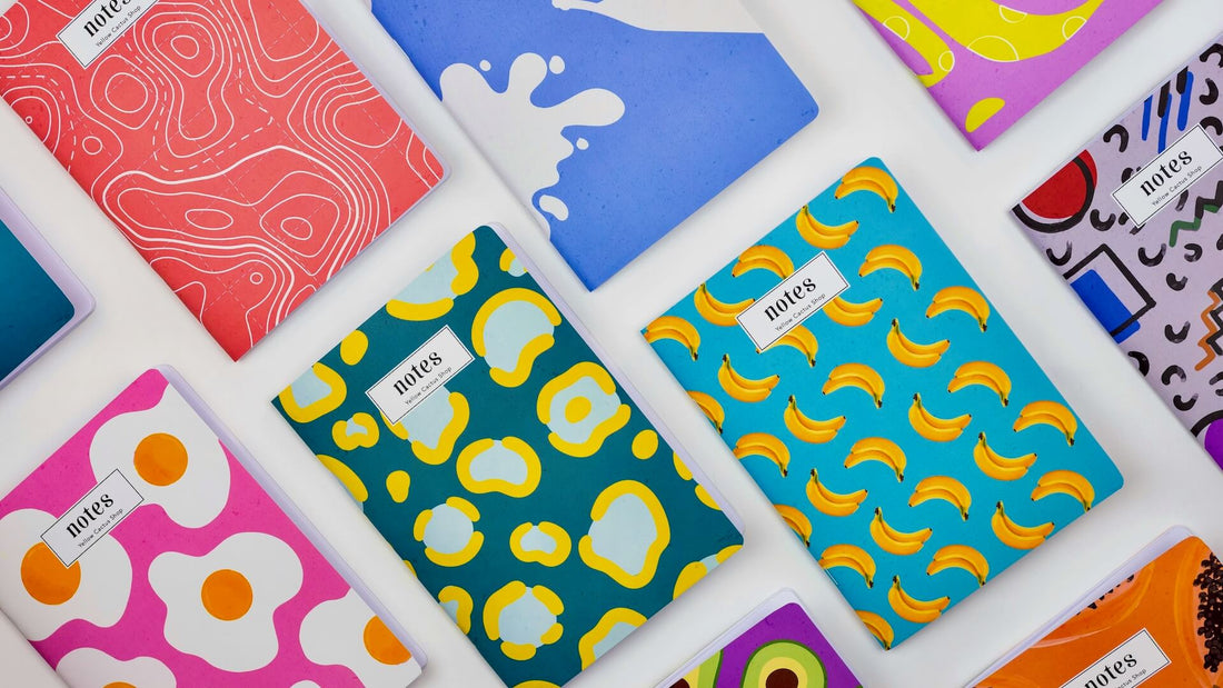 Colourful notebooks laid flat on a white surface.