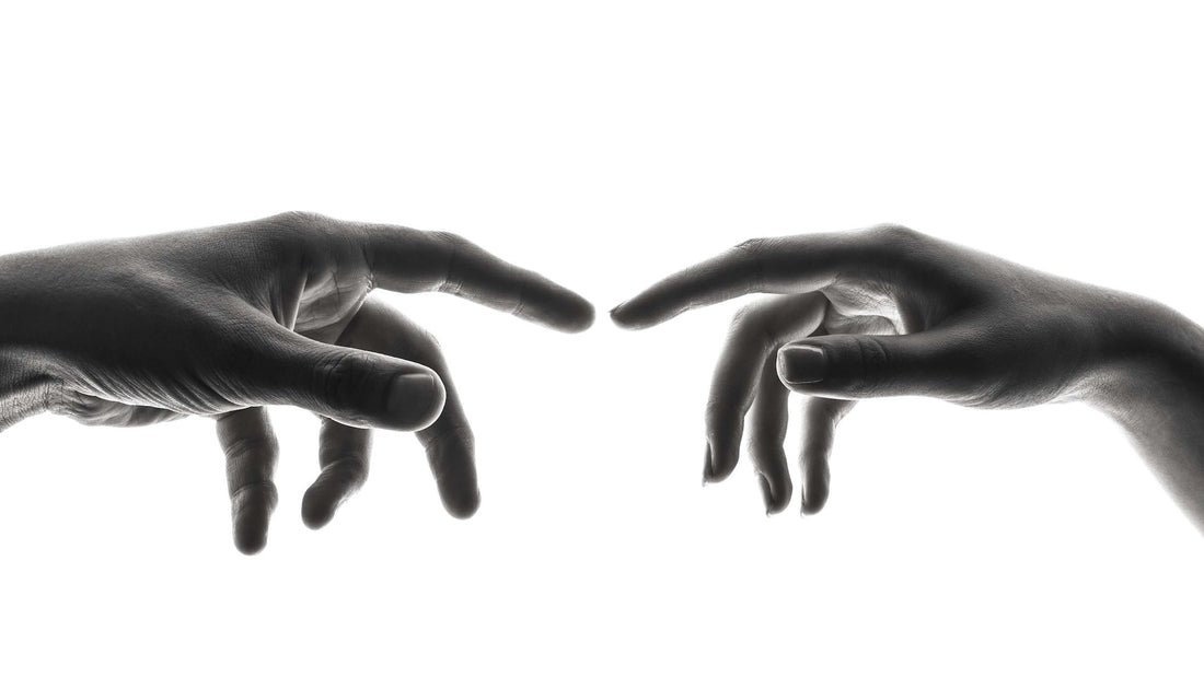 Two fingertips from opposite hands meeting, representing sinistral and dextral sides.