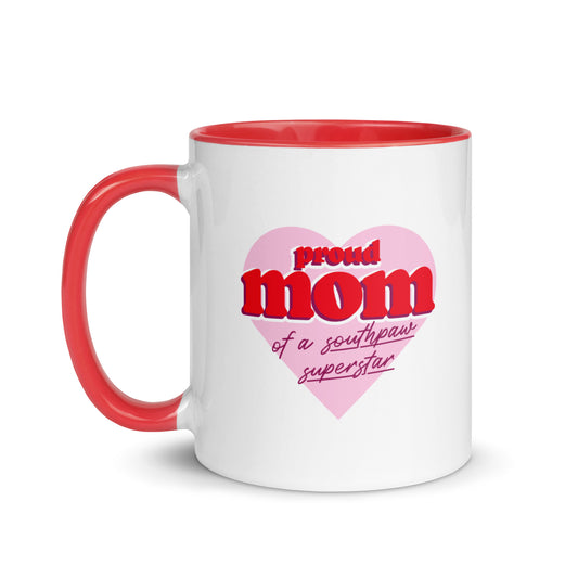 White ceramic mug for left-handers’ moms featuring the statement "Proud Mom of a Southpaw Superstar" in bold graphic text with red handle and interior.