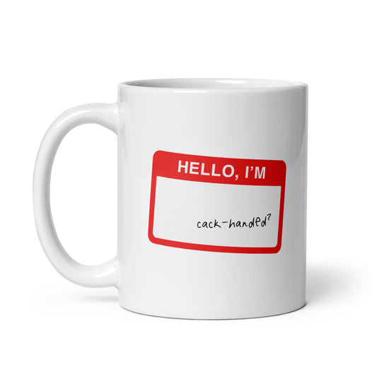 White ceramic mug for left-handers with hello i’m cack-handed sticker inspired design