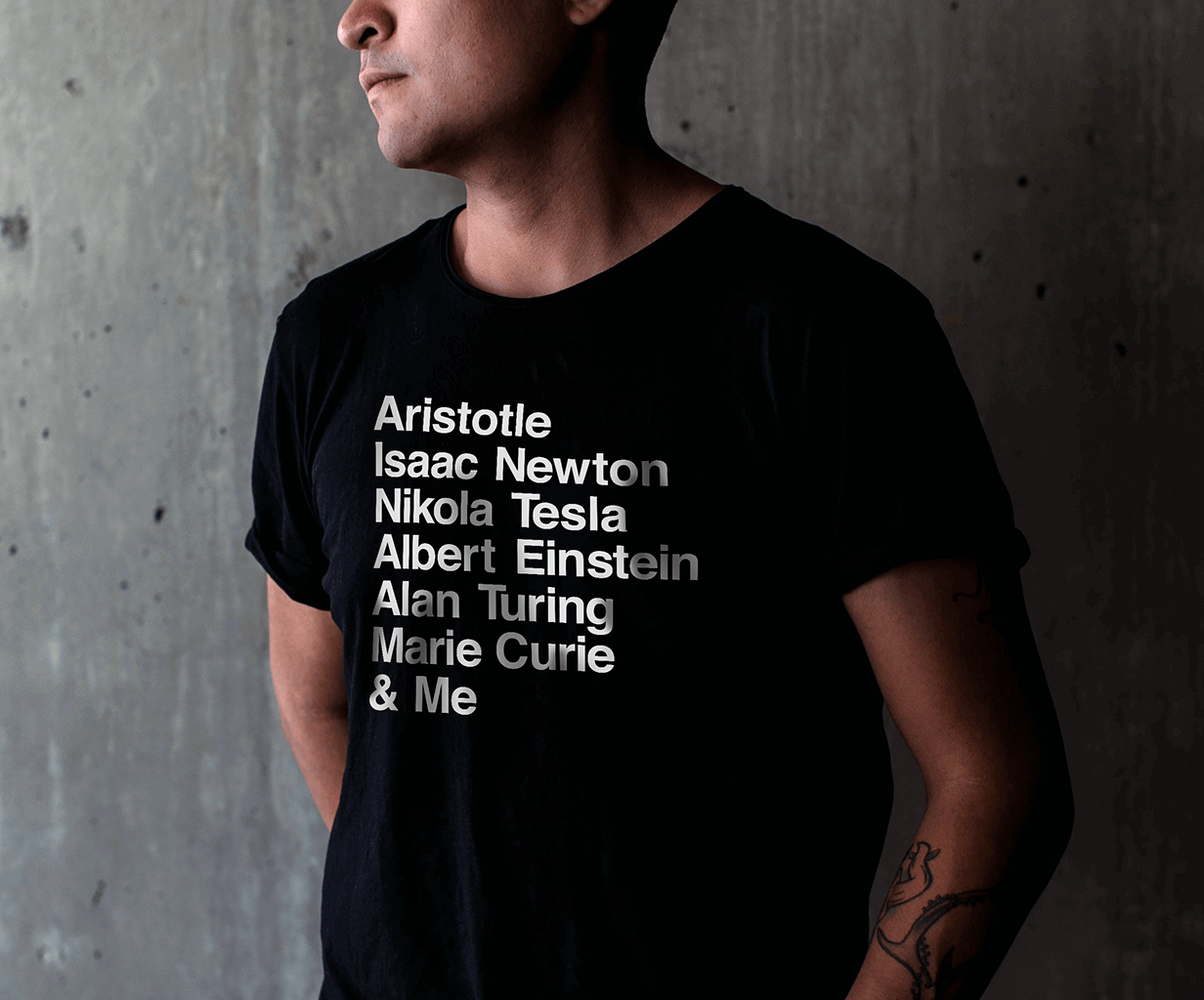 Man wearing black cotton t-shirt with a white text list of famous left-handed geniuses.